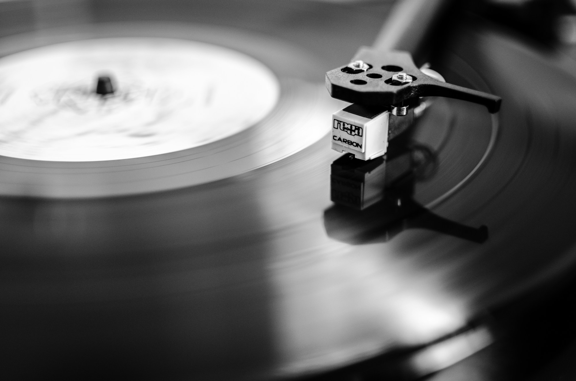 A stylus following the grooves of a vinyl record
